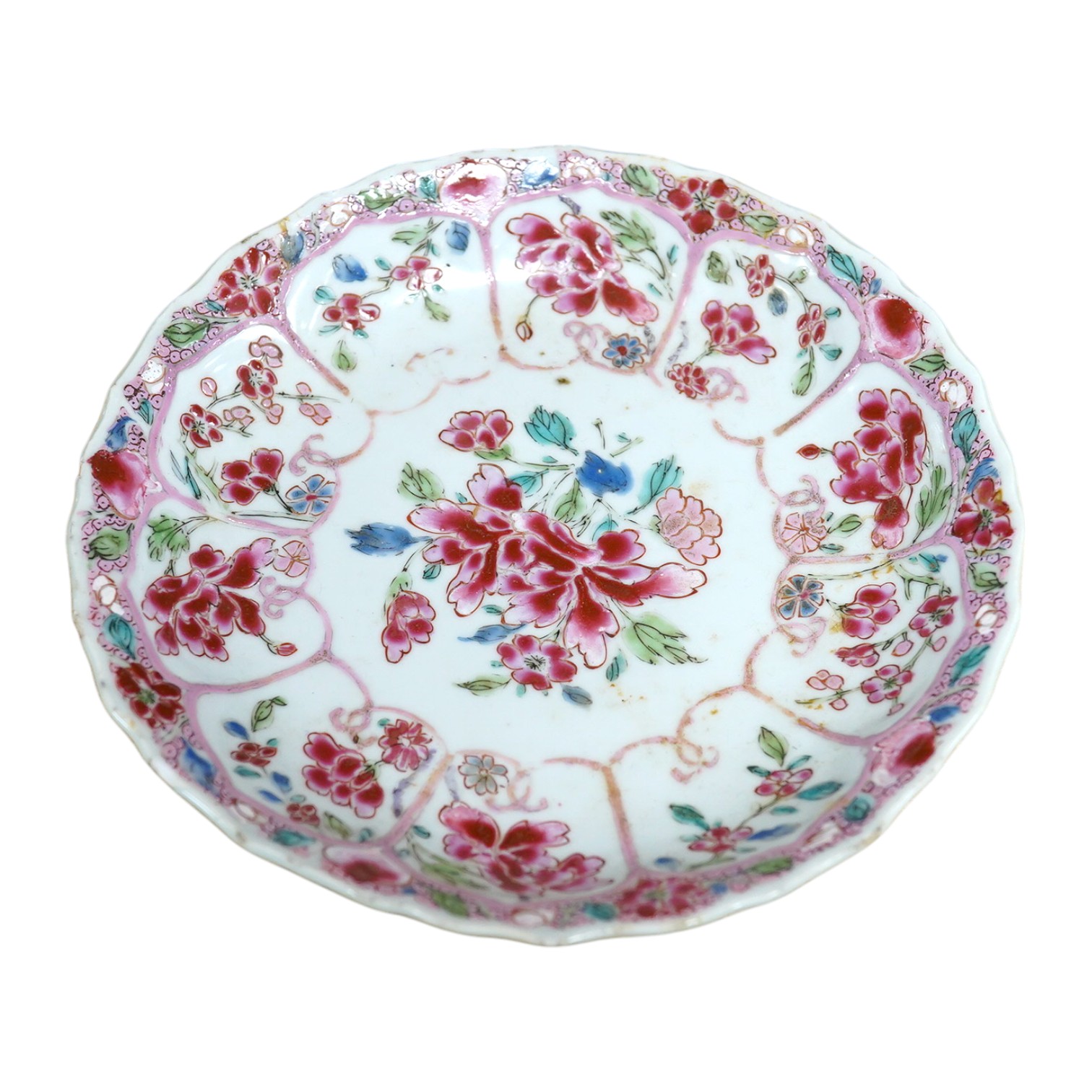 A Chinese famille rose moulded saucer dish, Yongzheng/Qianlong, 16cm in diameter. Condition - fair